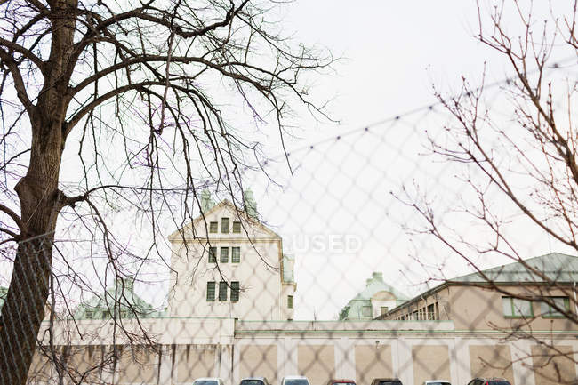 Building with fence in foreground — Stock Photo