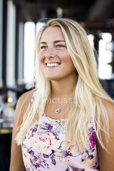 Young woman standing at restaurant — Stock Photo