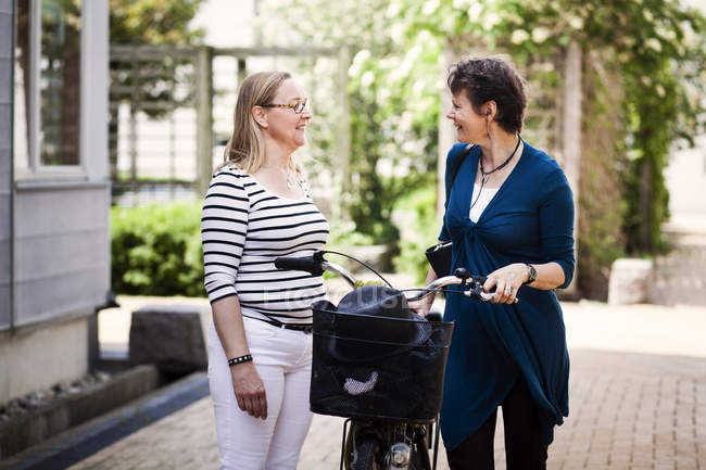 Mature woman talking with female friend — Stock Photo