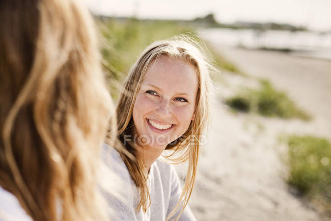 Woman looking at female friend — Stock Photo