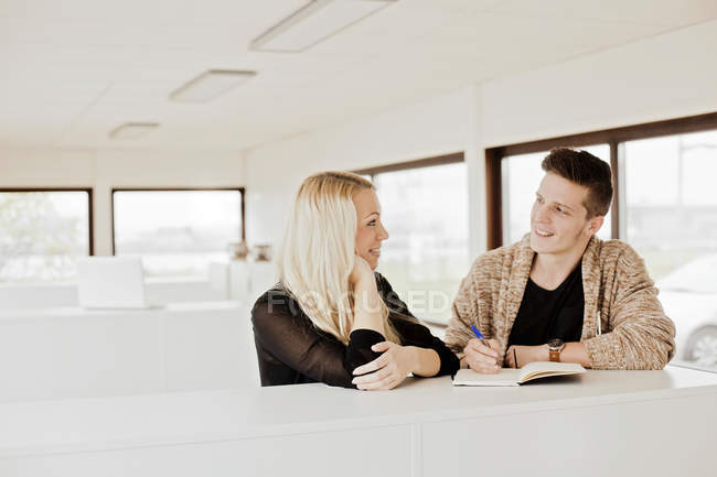 Business people smiling at each other — Stock Photo