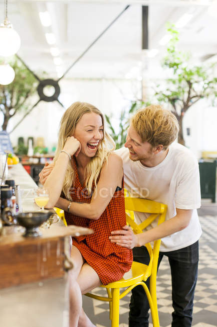 Happy couple at counter in cafe — Stock Photo