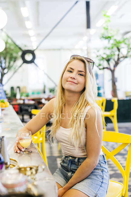 Portrait of young woman holding glass — Stock Photo