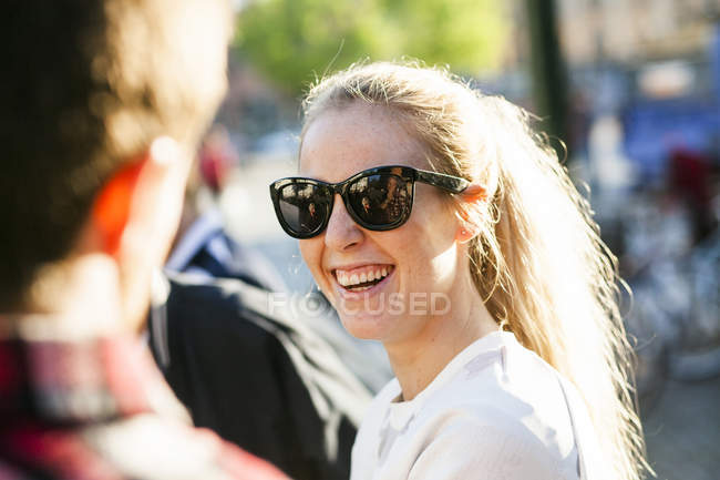 Cheerful woman looking at friend — Stock Photo