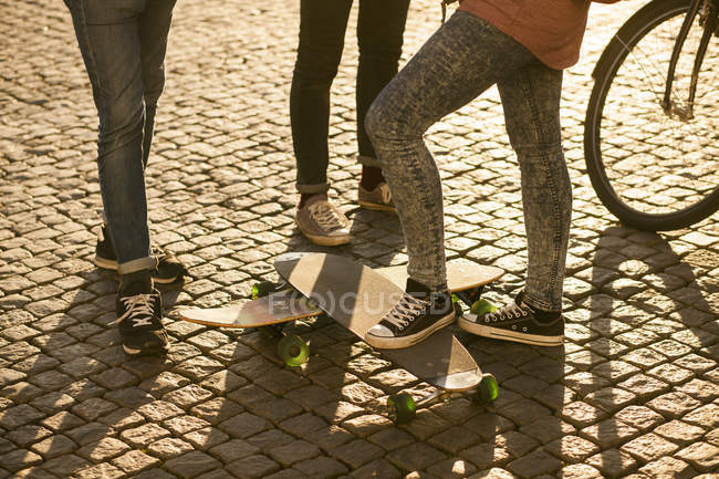 Friends standing with skateboards — Stock Photo