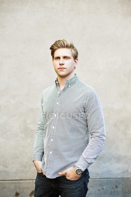 Man standing with hands in pockets — Stock Photo