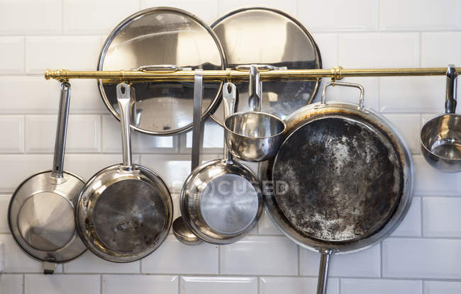 Kitchen utensils hanging in kitchen — Stock Photo