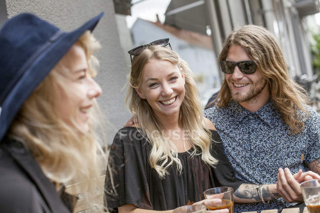 Happy couple with friend — Stock Photo