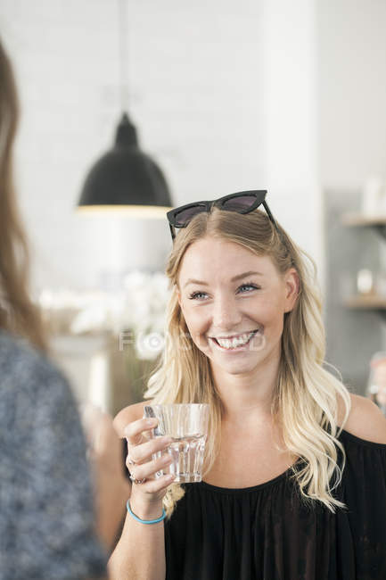 Woman holding drinking glass — Stock Photo