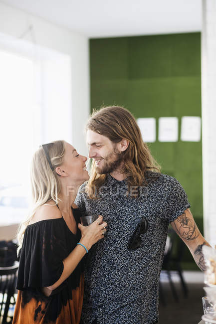 Loving couple standing in restaurant — Stock Photo