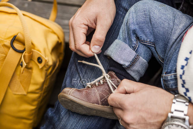 Padre atando cordón de zapato de niña - foto de stock