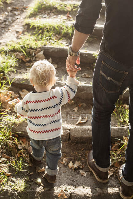 Baby girl holding hand of father — Stock Photo