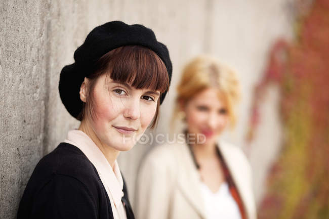 Female painters standing by wall — Stock Photo