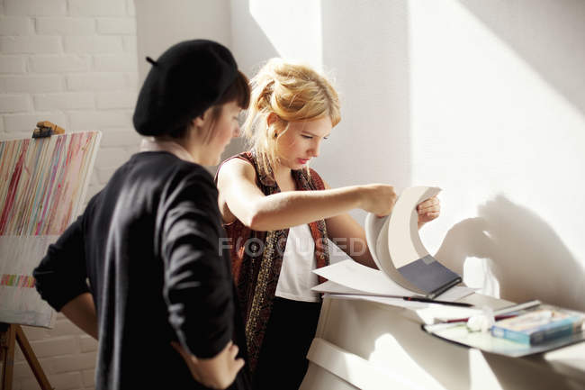 Painters discussing while looking at papers — Stock Photo