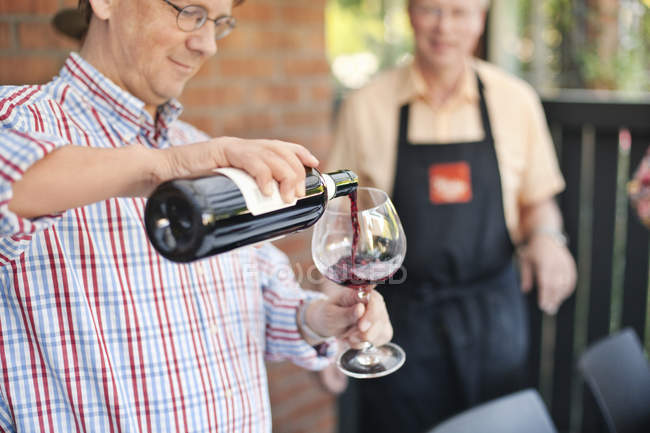 Man pouring red wine — Stock Photo