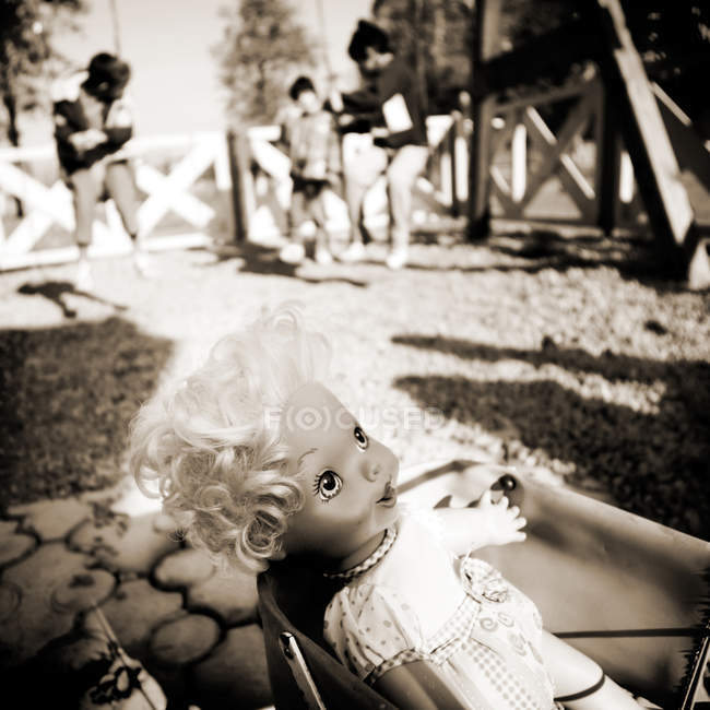 Abandoned doll in container — Stock Photo