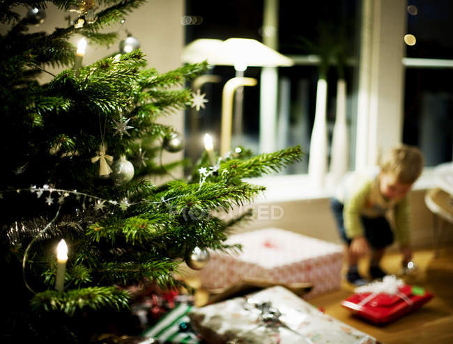 Boy picking gift at home — Stock Photo