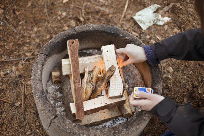Person igniting firewood — Stock Photo