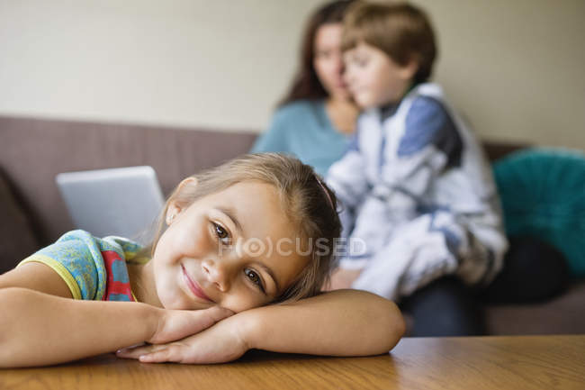 Happy girl leaning on coffee table — Stock Photo