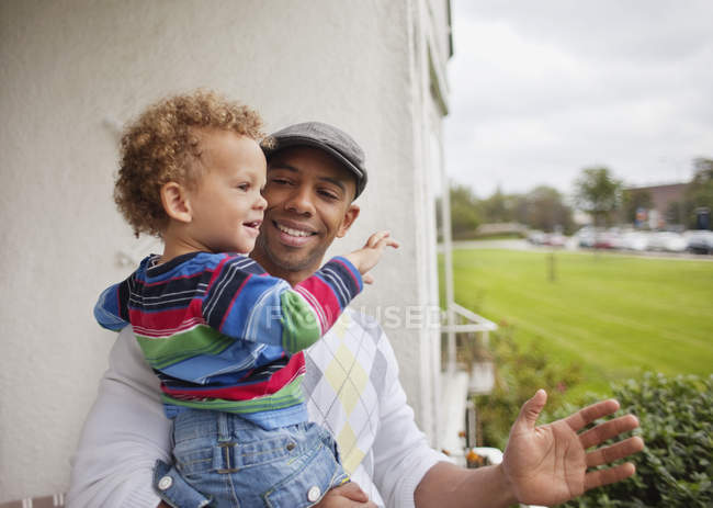 Father carrying son in balcony — Stock Photo