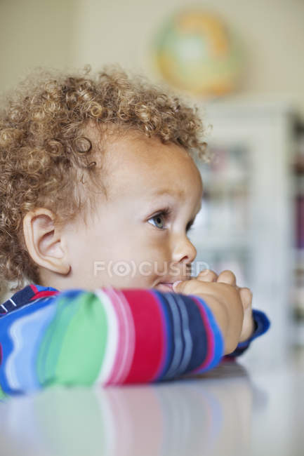 Boy at table in room — Stock Photo