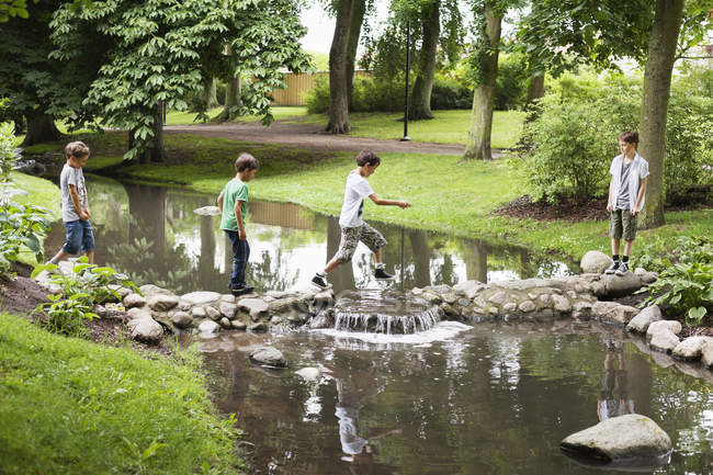 Boys crossing canal — Stock Photo