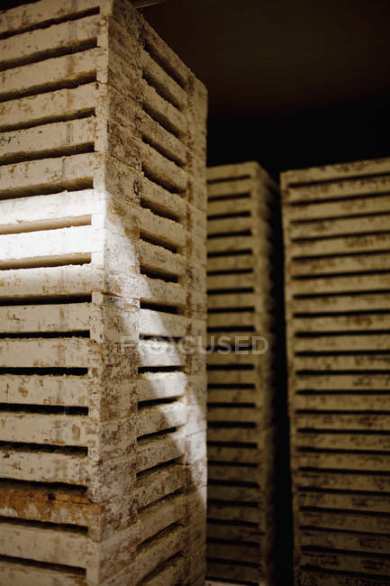 Weathered crates in dark room — Stock Photo