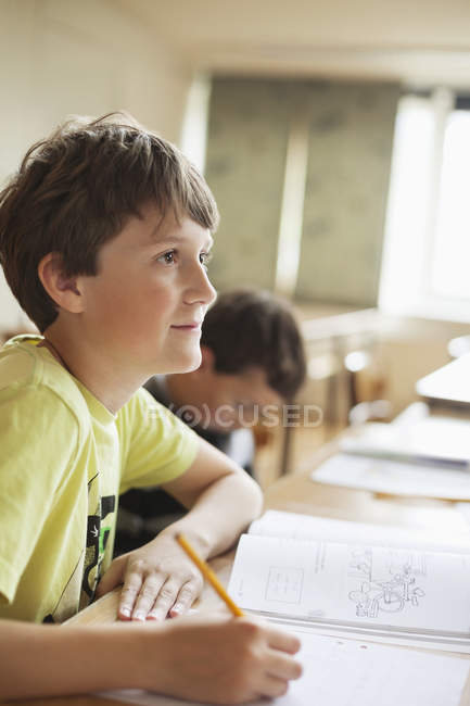 Boy writing in book — Stock Photo