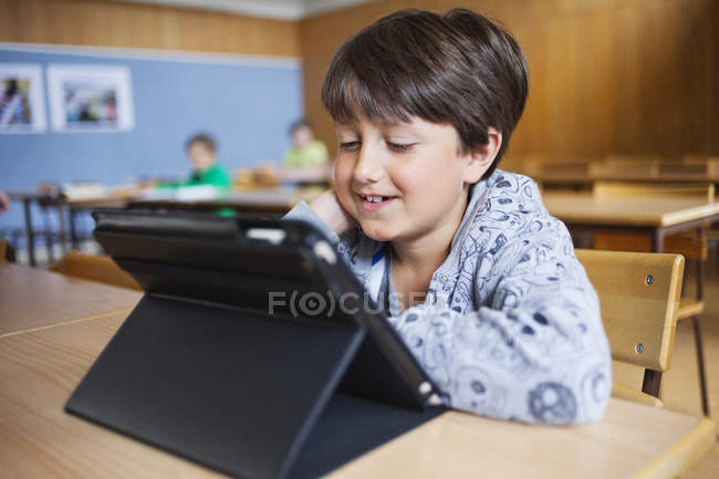 Happy boy using digital tablet — Stock Photo