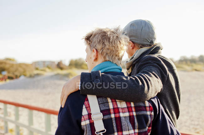 Young gay couple on pier — Stock Photo