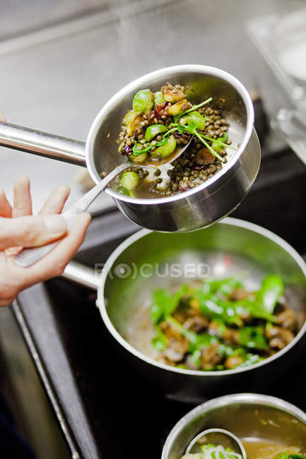 Chefs hand preparing food at restaurant — Stock Photo