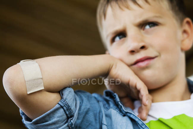 Boy with adhesive bandage — Stock Photo
