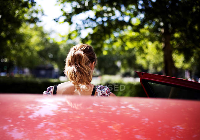 Woman getting out from car — Stock Photo