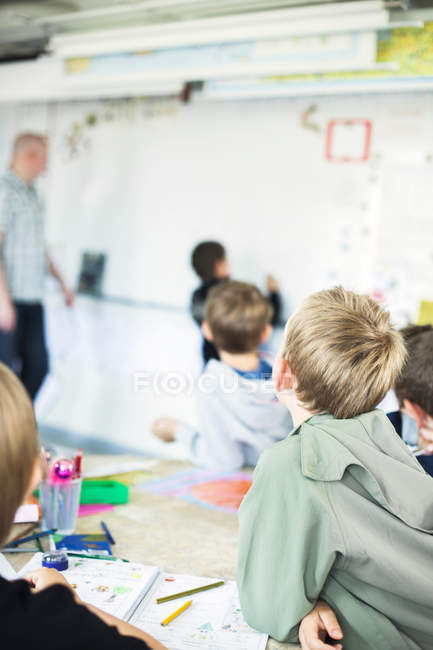 Enfants regardant camarade de classe — Photo de stock