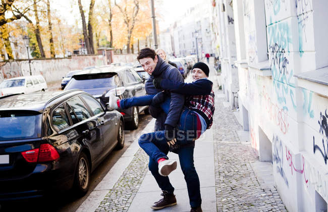 Man carrying male friend — Stock Photo