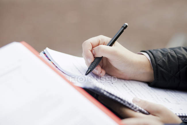 Woman writing in book — Stock Photo