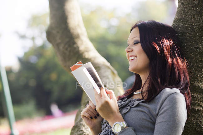 Estudante do sexo feminino leitura livro — Fotografia de Stock