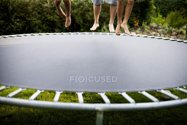 People jumping on trampoline — Stock Photo