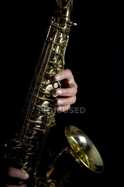 Hands playing saxophone — Stock Photo