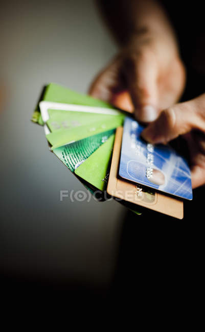 Hands holding various credit cards — Stock Photo