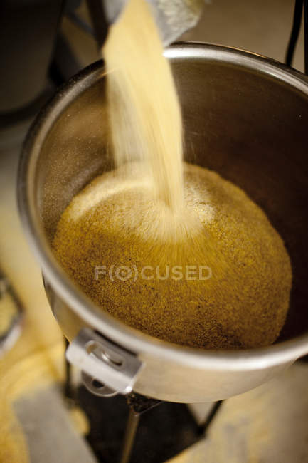 Grain being poured in container at factory — Stock Photo