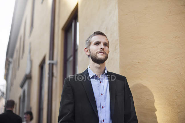 Handsome businessman standing — Stock Photo
