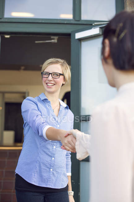 Happy businesswoman shaking hand — Stock Photo