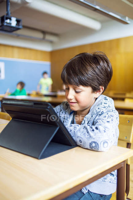 Schoolboy using digital tablet — Stock Photo