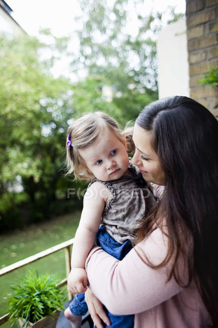 Woman carrying baby girl — Stock Photo