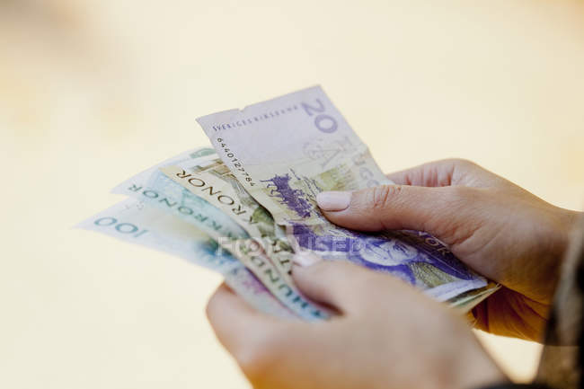 Woman holding Danish paper currency — Stock Photo