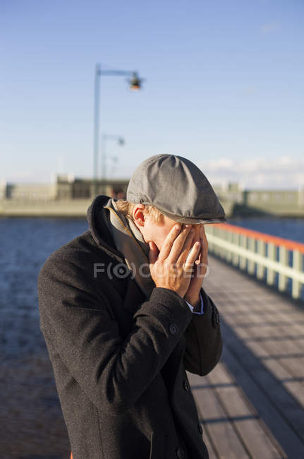 Young man covering eyes — Stock Photo