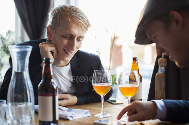 Gay couple using mobile phone — Stock Photo