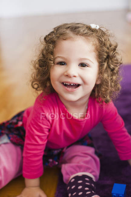 Happy girl sitting at home — Stock Photo