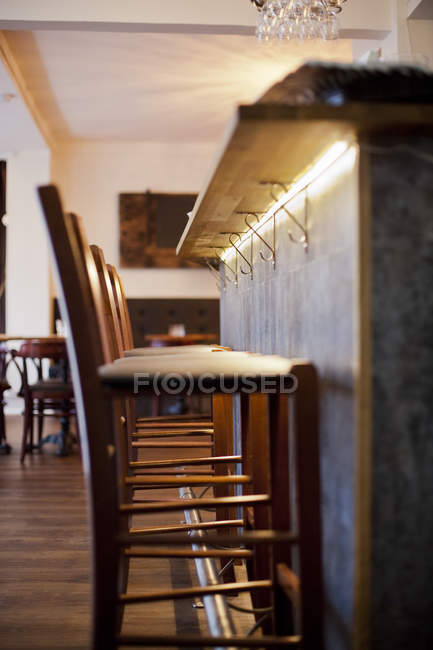 Bar stools at counter in restaurant — Stock Photo